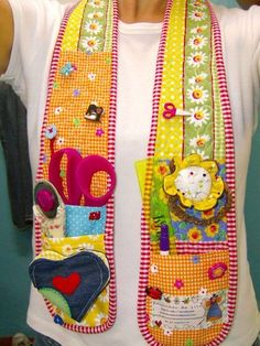 a woman wearing a colorful scarf with scissors and other items in it's pockets