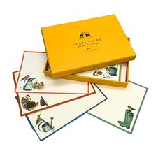 four cards in a yellow box with pictures on them