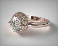 a white gold ring with an oval cut diamond in the center