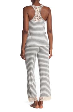 Lounge in ultimate comfort in this super soft scoop neck tank and pajama bottoms set. 2-piece set Top: 24" length; Pants: 13" rise, 29" inseam (size S) Top: scoop neck, sleeveless, racerback, knit construction, lace trim Bottoms: elasticized drawstring waist, pull-on style, knit construction, lace trim 95% rayon, 5% spandex Machine wash Imported Model’s stats for sizing: 5’11” height, 32” bust, 24” waist, 34” hips. Model is wearing size S. Casual Stretch Camisole For Loungewear, Casual Camisole Sleepwear For Loungewear, Casual Camisole Sleepwear, Casual Camisole Sleepwear For Lounging, Casual Cotton Camisole For Pajama Party, Spring Camisole For Pajama Party, Stretch Camisole For Loungewear, Pajama Bottoms, Honeydew