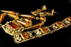 "This is a very beautiful, old and unique ART NOUVEAU NEIGER CZECH CRYSTAL BRASS ENAMEL c, 1920 bracelet and necklace set. The set has a marvelous Art Nouveau style, enamel, flower decoration, faceted citrine crystal, brass. The set has a very extravagant and elegant feel to it. The bracelet measures 7 1/4\" x 3/4\", necklace 15 3/4\" long and 1 1/2\" x 1\" center. The set is in very good condition. 0.7 BR" Antique Jeweled Jewelry For Formal Occasions, Antique Hallmarked Jewelry For Evening, Antique Formal Jewelry, Collectible Art Nouveau Yellow Gold Jewelry, Antique Jeweled Yellow Gold Jewelry, Antique Yellow Gold Jeweled Jewelry, Victorian Jeweled Evening Jewelry, Victorian Yellow Gold Jeweled Jewelry, Antique Yellow Gold Jewelry With Jewels