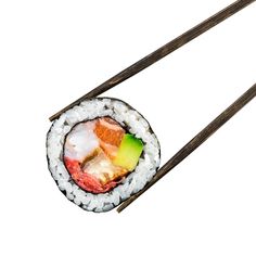 two chopsticks with sushi and avocado on them sitting next to each other