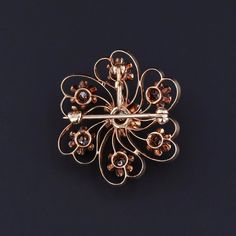 This antique brooch (circa 1890) features 7 old European cut diamonds set in 14k gold. The center diamond is a 0.12ct stone and the total carat weight of all the diamonds is approximately 0.57ct. The piece has a collapsible bail so that the it can be worn either as a brooch or a pendant. The diamond brooch measures 1.25 inches from the top of the bail (when extended) to bottom by 1 inch wide, and it is in great condition. Materials: 14k gold, Diamond. Victorian Diamond Filigree Brooches, Antique Gold Brooches With Rose Cut Diamonds, Antique Gold Brooches With Diamond Accents, Vintage Yellow Gold Brooches With Rose Cut Diamonds, Victorian Diamond Jewelry With Screw Back, Victorian Gold Diamond Brooches, Antique Gold Diamond Brooches, Heirloom Diamond Brooch With Rose Cut Diamonds, Heirloom Diamond Brooches With Rose Cut Diamonds