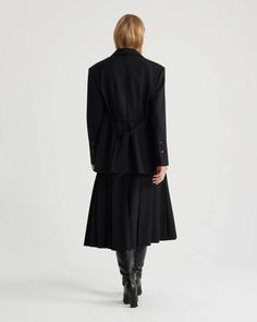 The Oversized Belt Jacket in Black by Patou is a relaxed fit, belted blazer featuring notch lapels, JP-engraved buttons and removable belt crafted in a black technical wool twill. 97% RWS virgin wool, 3% elastane Patou label on the left sleeve. Lining: 100% viscose Made in Romania JA0380103999B Tailored Black Belted Blazer, Formal Black Belted Outerwear, Formal Black Outerwear With Belt Detail, Classic Formal Outerwear With Belt Detail, Tailored Formal Outerwear With Belt Detail, Tailored Outerwear With Belt Detail For Work, Belted Business Blazer For Winter, Black Blazer With Belt Loops For Office, Tailored Winter Blazer With Belt Loops