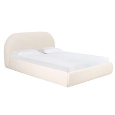 a bed with white sheets and pillows on it