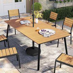 an outdoor dining table with four chairs around it