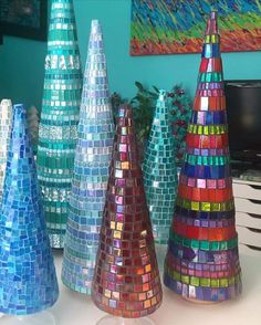 several colorful vases sitting on top of a table