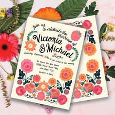 two wedding cards with flowers and leaves on the table next to each other, which reads you're celebrating this anniversary victoria & mica