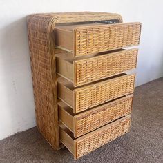 three wicker drawers stacked on top of each other in front of a white wall