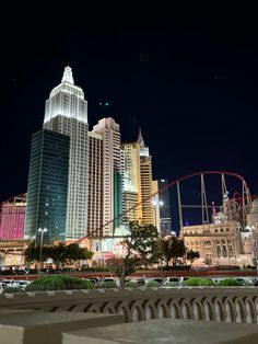 the city skyline is lit up at night