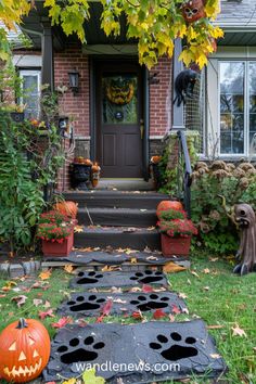 a house decorated for halloween with pumpkins and jack - o'- lantern decorations