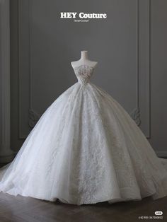 a white wedding dress on display with the words hey couture written above it