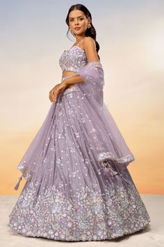 Experience unparalleled elegance with our exquisite Wedding Wear Lehenga Choli set. It comprises a semi-stitched Lehenga, an unstitched Choli, and a gorgeous Dupatta, all accented with scintillating Sequins Work. The Lehenga provides ease-of-use with a Drawstring closure, and the Blouse with three-quarter sleeves keeps it chic. Bear in mind, there might be a slight difference in color due to variations in fabric dyes, weather, and display settings. Lehenga For Sisters Wedding, Lehenga For Groom's Sister, Lehanga Idea, Bridesmaid Lehenga Sisters, Mauve Lehenga, Lavender Lehenga, Lehenga Ideas, Chiffon Lehenga, Elegant Lehenga