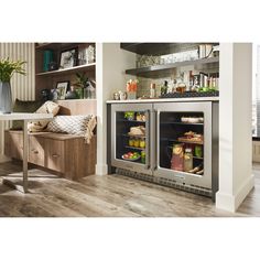 an open refrigerator with drinks in it next to a counter