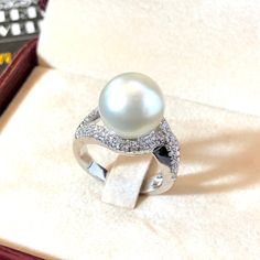 Genuine SOUTH SEA PEARL, absolutely natural color and luster, 12.0 mm in size, surrounded by 72 pieces of hand-set F/VS superb quality diamonds, weighting at 0.63 carats. Set in handcrafted, one of a kind 18K solid white gold ring, weighting at 9.0 grams. The pearl is naturally cultured from South Australia Sea, its luster is extra fine, AA+ grade with 90% clean surface. Color is pure white. The shape is round. SUGGESTED RETAIL PRICE: $5,850 The ring is hand crafted to a high standard and is NOT Luxury White Pear-shaped Diamond Ring, Formal White Pear-shaped Diamond Ring, White Pear-shaped Cubic Zirconia Ring, Pear-shaped White Cubic Zirconia Ring, Luxury White Pear Shaped Rings, White Pearl Platinum Ring With Diamond Accents, White Pearl Ring With Diamond Accents In Platinum, White Pear-shaped Diamond Ring As Gift, Silver Platinum Pearl Ring For Anniversary