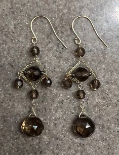 "Vintage 14K Yellow Gold Brown Quartz Chandelier Earrings Beautiful pair of 14k yellow gold earrings that each have 6 faceted brown quartz gemstones.  Marked 14K on the hooks. Measures- 2\" long Weighs- 3.7 Grams In good vintage condition Will ship in a gift box. Stock #E1702 As with all jewelers, I do enlarge pictures of the jewelry.  This is to your advantage, so you can see all details more clearly.  I do provide measurements of the jewelry, so be sure to review it to better understand the true size of the item. Please consider the measurements carefully.  I recommend grabbing a ruler or tape measure and visualizing the item." Elegant Brown Chandelier Earrings, Quartz Chandelier, Tiara Accessories, Quartz Gemstones, Yellow Gold Earrings, Buy Earrings, 90s Outfit, Heart Pendant Diamond, Black Earrings