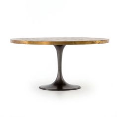 an oval dining table with a gold top and black metal base, against a white background