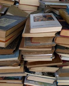 a pile of books sitting on top of each other next to an iphone phone screen