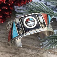 Incredible Vintage Find Right HERE! This Beauty was created by the Famous Zuni Artist Don Dewa. This Bracelet Cuff has Incredible Inlay work & Detail. Turquoise, Onyx, Coral and Mother of Pearl placed so Intricately. Center Design has a two face Design that moves . It is made of Sterling Silver and Multi Stones. The inside circumference is 5 1/4 inches with a 1 1/4 inch gap. Width is 1 1/8 inches wide. This piece is signed by the artist and Stamped Sterling. Thank you for looking at our items. P Luxury Southwestern Jewelry For Anniversary, Luxury Multicolor Southwestern Style Jewelry, Luxury Southwestern Collectible Jewelry, Luxury Southwestern Jewelry With Sterling Silver Clasp, Zuni Jewelry Yourgreatfinds ♥ Vintage Jewelry, Two Face, Zuni Jewelry, Turquoise Jewelry Native American, Turquoise Earrings Dangle