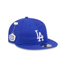 The Los Angeles Dodgers Team Color Retro Crown 9FIFTY Adjustable Cap features an embroidered Dodgers Cooperstown logo at the front panels with a matching MLB Batterman logo at the rear. Additional details include a removable team pin chain at the right-wear side, a gray undervisor, and an adjustable strapback closure at the rear. Chocolate Skateboards, All Nfl Teams, Diamond Supply Co, Strapback Hats, Vancouver Canucks, Utah Jazz, Houston Rockets, Indianapolis Colts, Cincinnati Bengals