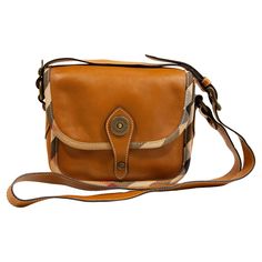 A Burberry crossbody bag made of light brown leather with the Burberry check canvas trim and old brass toned hardware. The interior is lined with brown canvas, and next to the major compartment it features one side pocket with a zipper and one slide pocket. The shoulder strap in length adjustable, max. 112 cm. The bag is in very good condition. Measurements Width:19 cm Height:16 cm Depth:8 cm Burberry Crossbody Bag, Burberry Shoulder Bag, Gucci Mini, Light Brown Leather, Vintage Bag, Brown Canvas, Canvas Shoulder Bag, Designer Bag, Burberry Bag