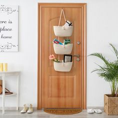 a wooden door with three baskets hanging on the front and side shelves above it that hold personal items