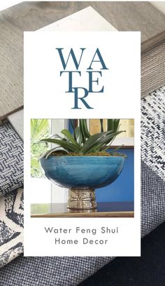 a blue bowl sitting on top of a table next to a rug and pillow with the words water feng shui home decor