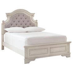 a white bed with an upholstered headboard and two drawers on each side