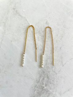 "Super dainty threader earrings with teeny tiny white or peach rice seed pearls hanging from gold filled chain or sterling silver chain. Seed pearls are tiny, 2mm-3mm size.  Earring is 3.5\" tip to tip. So lightweight you can barely feel them. Sold as a pair." Delicate 14k Gold Filled Threader Earrings, Dainty Long Drop Pearl Earrings For Everyday, Delicate 14k Gold Filled Linear Earrings For Everyday, Everyday 14k Gold Filled Long Drop Pearl Earrings, Minimalist Pearl Drop Threader Earrings, Gold Sterling Silver Pearl Chain Earrings, Dainty 14k Gold Filled Linear Earrings For Everyday, Dainty 14k Gold Filled Earrings, Dainty Dangle Threader Earrings For Everyday