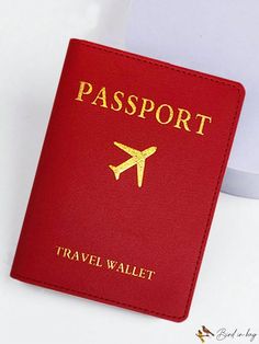 a red passport sitting on top of a white table