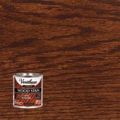 a can of wood stain sitting on top of a wooden table