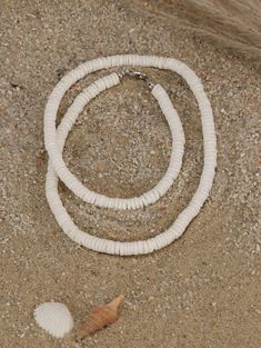 "This choker necklace features quality white shell heishi beads. The literal meaning of heishi (pronounced hee-shee) is \"shell\" and these beads are made using pieces of oyster shell (also known as mother-of-pearl) made into flat beads. A string of good heishi will have a uniform consistency in bead size and if you gently pull it through your hand, it should feel like a single serpent-like piece. When you look closely at each bead, you see the amazing detail and unique coloration of each bead. Pula Shell Necklace, White Heishi Beads Single Strand Necklace, White Single Strand Heishi Beads Necklace, Beach Jewelry With White Letter Beads, White Heishi Beads Single Strand Jewelry, White Letter Beads Jewelry For Beach, White Beach Jewelry With Letter Beads, White Jewelry With Letter Beads For Vacation, Adjustable Single Strand Shell Necklace For Beach