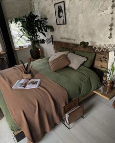 a bed room with a neatly made bed and lots of pillows on top of it