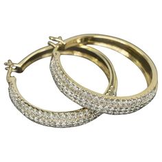 Indulge in the timeless allure of these pave diamond hoop earrings, delivering a classic aesthetic enriched with radiant sparkle. Comprising 1.50 carats of natural diamonds, these earrings captivate with a fantastic and eye-catching brilliance. The diamonds, graded G-H SI1-SI2, exhibit bright white and eye-clean qualities, ensuring a scintillating display that is both bright and lively. Set in substantial 10k yellow gold, the earrings boast a durable and luxurious foundation. With dimensions mea