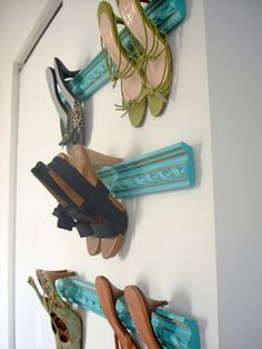 several pairs of shoes are hanging on the wall