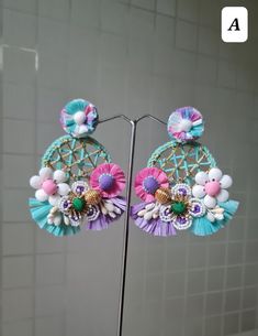 Handmade Statement Floral Pink-Purple - Blue Hoop Earrings. These stunningly beautiful, purely handmade and handcrafted,intricate earrings are made using raffia, handmade flowers, fabric pompoms, glass beads, and a lot more. The earrings have unique intricate workmanship and undoubtedly beautiful. The earrings are ideal for day parties or just wear them as you want.. The earrings measure approx. 3.20" long and 2.60" wide. Available in two color options: A and B At Carnation jewellery, each piece is artisan handcrafted with love and care and shipped from India.  * SHIPPING - Please refer to the "announcement" page of the store. * Please be noted all kind of taxes, custom duties, VAT etc will be borne by the buyer as I am not responsible for the same. * For queries, please reach out to me an Bohemian Dangle Hoop Earrings For Spring, Pink Hoop Earrings For The Beach, Multicolor Bohemian Hoop Earrings For Spring, Pink Bohemian Earrings For Spring, Bohemian Spring Hoop Earrings For Party, Bohemian Pink Earrings For Spring, Pink Hoop Flower Earrings For Spring, Handmade Multicolor Flower Earrings For Spring, Pink Flower Hoop Earrings For Spring