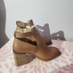 New Size 39.5 Geometric Side Cutouts And A Square Toe Lend Contemporary Dimension To A Smooth Leather Boot Lofted By A Stacked Block Heel. Adjustable Buckle 3" Heel Brown Leather Shoes With Heel Strap For Spring, Brown High Heel Leather Shoes With Heel Strap, Brown Closed Toe Leather Shoes With Heel Strap, Chic Closed Toe Leather Shoes With Branded Heel, Chic Leather Shoes With Branded Heel Counter, Leather Shoes With Heel Strap And Almond Toe, Chic Medium Width Closed Toe Leather Shoes, Almond Toe Leather Shoes With Heel Strap, Leather Heels With Removable Insole And Pointed Toe