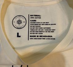 a white shirt with black print on the front and back side that says material care