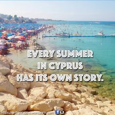 there is a beach with many umbrellas and people in the water at this time