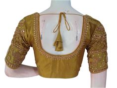 Elevate your saree ensemble with this exquisite tissue mustard Aari handwork blouse. The intricate gold embroidery and delicate beadwork create a stunning and timeless piece. This ready-to-wear blouse is perfect for any special occasion and ensures a hassle-free fit. * This Is A Fully Stitched Saree Blouse, Ready To Wear * Made of Tissue silk, Lined With Cotton * Opens From Front With Hook and eye-fitting MEASUREMENTS: Sleeve: 10 inches  Size: 38,40,42 Blouse Length: 15 inches  Neck Depth: Front Bridal Saree Blouse, Handwork Blouse, Stitched Saree, Saree Blouses, Gold Embroidery, Bridal Saree, Blouse Length, Handmade Design, Saree Blouse