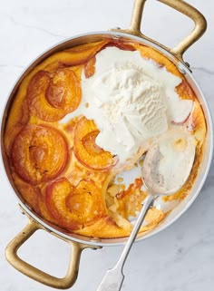 a pan filled with fruit and ice cream on top of a table