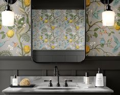 a bathroom sink under a large mirror with yellow flowers on it