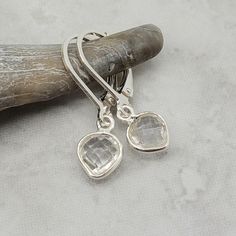 "Enticing little clear crystal quartz hearts swing from sterling silver leverback earrings. Small and lightweight - great for someone who doesn't love big jewelry. The April birthstone is diamond. The petite clear quartz stones are 10x7mm in size and are created from hydrothermal quartz. Total drop length of the earring is about 1\" long (2.54 cm). Sterling silver leverback earrings. Items are shown larger in pictures to show detail - please note the dimensions. Jewelry is packaged in a blue cot Silver Teardrop Crystal Earrings For Everyday, Everyday Silver Teardrop Crystal Earrings, Hypoallergenic Sterling Silver Crystal Earrings For Everyday, Minimalist Clear Crystal Earrings For Gift, Minimalist Clear Crystal Earrings Gift, Everyday Hypoallergenic Sterling Silver Crystal Earrings, Everyday Silver Dangle Crystal Earrings, Dainty Sterling Silver Crystal Earrings For Everyday, Everyday Sterling Silver Clear Earrings