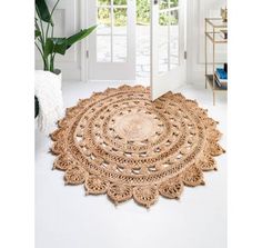 a large round rug on the floor in front of a white door with an open window