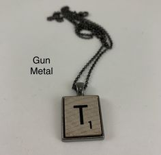 a necklace with the letter t on it