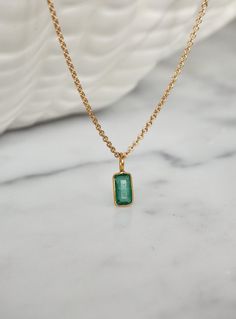 This tiny emerald necklace is the perfect daily necklace for emerald  lovers and May babies! The necklace is 14k gold filled with a beautiful natural Zambian Emerald pendant in a vivid green color in 18k solid gold setting. So beautiful! Layer it with your favorite necklaces, or wear it alone - it's perfect either way! Made using the highest quality USA and UK sourced materials. The pendant is very small, approximately 6.50x3.75mm. Each stone is unique and there will be slight variations in size Minimalist Emerald Necklace In Yellow Gold, Minimalist Gold Emerald Gemstone Necklace, Gold Emerald Birthstone Necklace In Minimalist Style, Gold Minimalist Emerald Birthstone Necklace, Minimalist Gold Emerald Birthstone Necklace, Minimalist Gold Emerald Necklace In Sterling Silver, Dainty Gold Emerald Birthstone Necklace, Dainty 14k Gold Emerald Necklace, Emerald Necklaces For Everyday Wear, May Birthstone