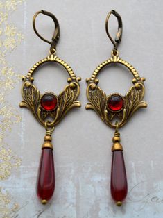 Vintage Red Teardrop Jewelry, Ornate Red Teardrop Jewelry, Antique Gold Victorian Brass Earrings, Victorian Antique Gold Brass Earrings, Vintage Antique Gold Earrings With Intricate Design, Festive Vintage Brass Earrings, Vintage Red Brass Earrings, Vintage Teardrop Copper Jewelry, Ornate Red Dangle Earrings