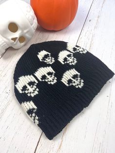 Black Skull Mens Beanie Cap Hand knitted Wool Cap with Skull  Unisex design, handmade  Perfect beanie for this Winter. Made with 100%  New Zealand  wool, lined with soft fleece.  Unique gift for your loved ones who are into gothic style.  Warm cap to wear every day or for hiking, running, skiing, or any outdoor activities.  Hand wash separately in cold water, flat dry. Stretches to fit into comfortable size. Approximate measurements:  Height-9" Width-10"  Black and Ivory color combination with s Skull Halloween Hat One Size Fits Most, Halloween Skull Hat One Size Fits Most, One Size Fits Most Skull Hat For Halloween, Halloween Skull Hat, One Size Fits Most, Black Knitted Hat For Halloween, Black Novelty Beanie, Black Novelty Beanie One Size Fits Most, Novelty Black Beanie, One Size Fits Most, Black Skull Print Hat