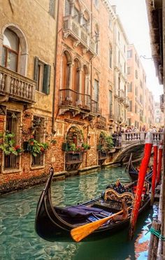 a gondola is parked on the side of a narrow canal in venice, italy