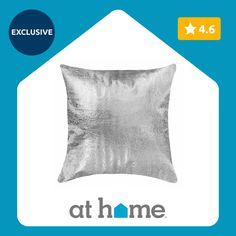 a silver pillow with the words at home on it and an image of a house